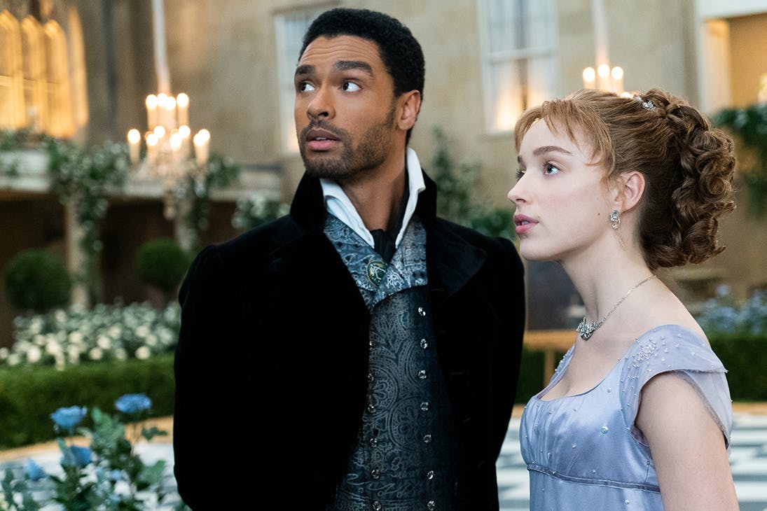 a young man and woman, in 1900s costume, look up at the sky